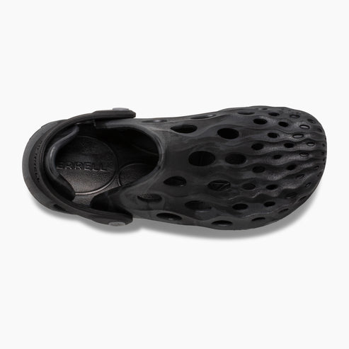 Overhead view of a black rubber clog with rounded toe and heel, adjustable heel strap, and an upper covered in many circular holes.