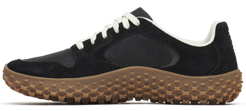 A black sneaker with a brown bumpy sole and white laces.
