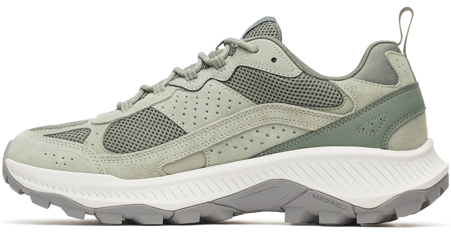 A sage green suede sneaker with white jagged midsoles and grey outsoles.