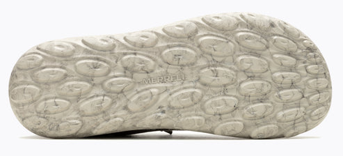 Textured shoe sole with circular indentations and the word "MERRELL" embossed.