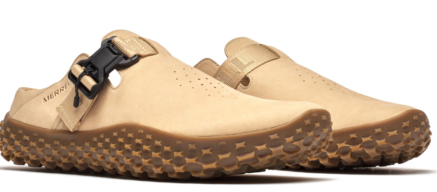Pair of beige clogs with thick, textured brown soles and a black buckle strap.