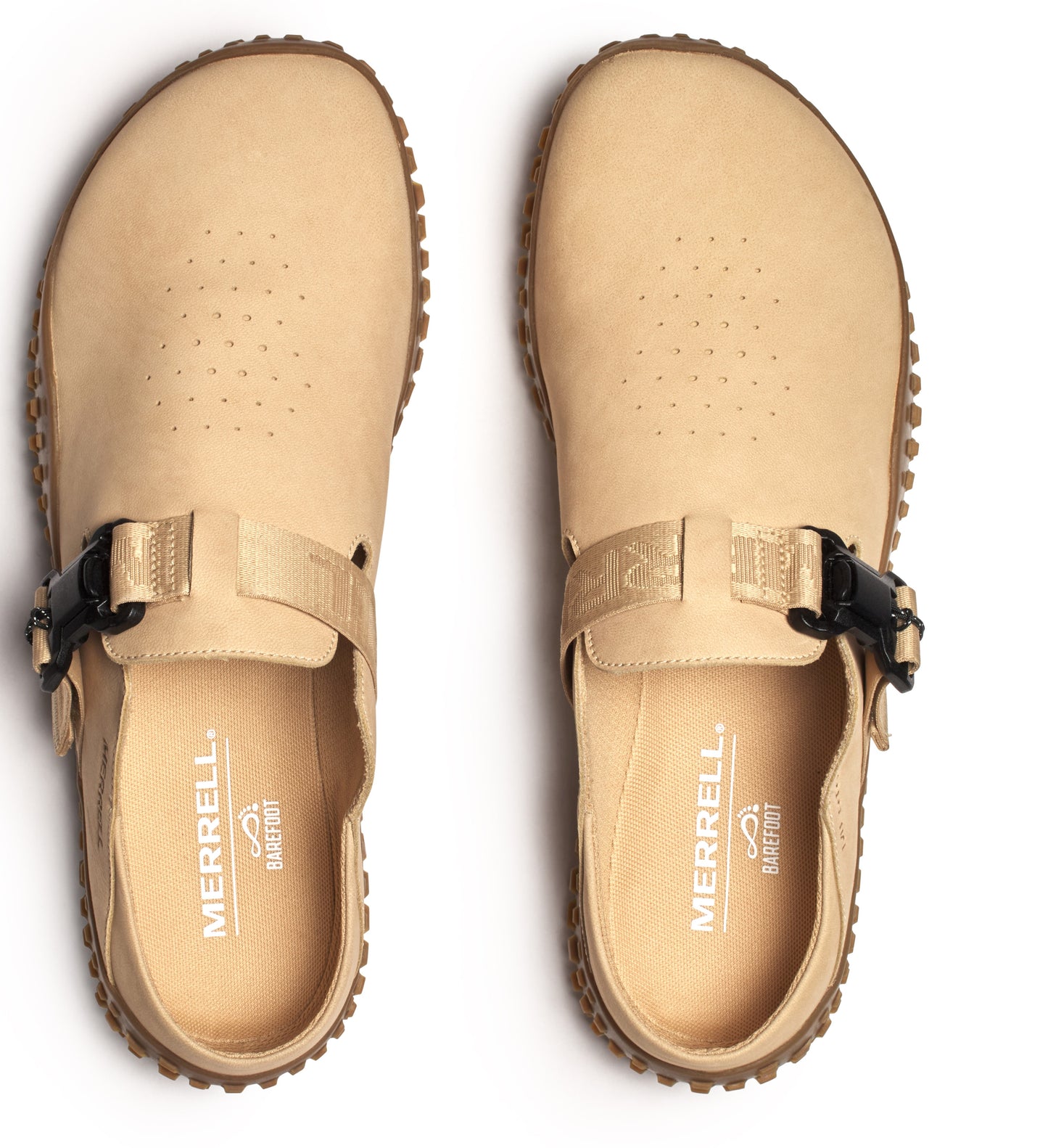 Overhead view of two beige clogs with a buckle strap and a textured sole.