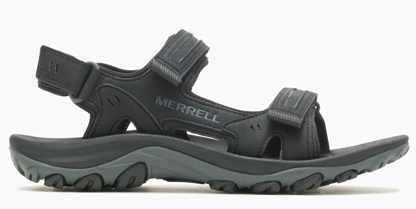 A black sandal with velcro straps and the word "MERRELL" printed on the side.