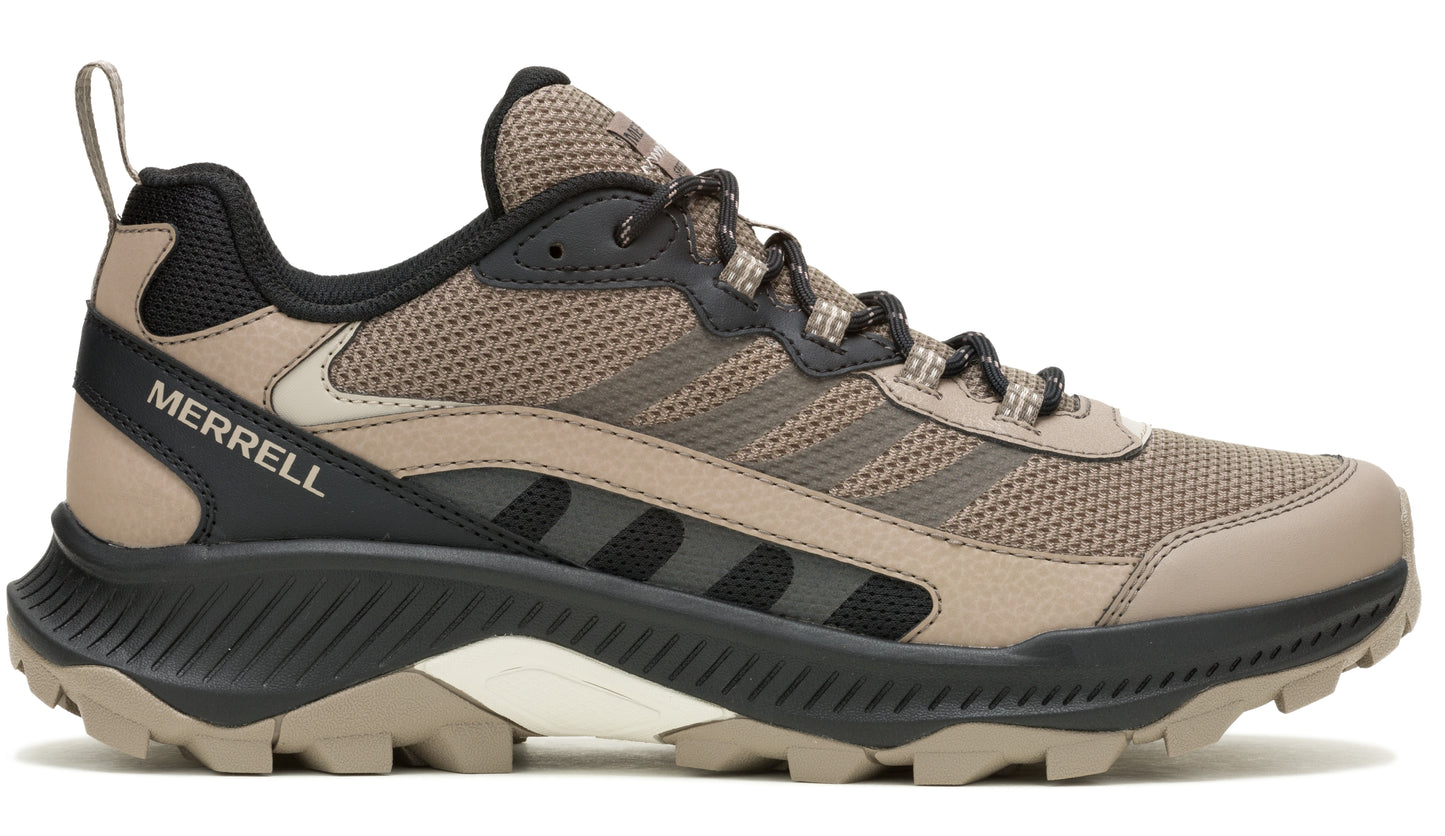 A low cut hiking shoe featuring a beige and black color scheme with visible "MERRELL" logo.