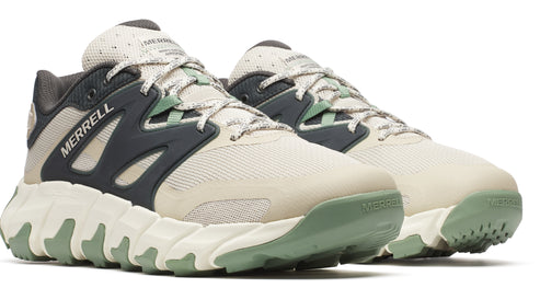 Pair of beige sneakers with dark gray accents and textured green soles, displaying the word "MERRELL" on the side.