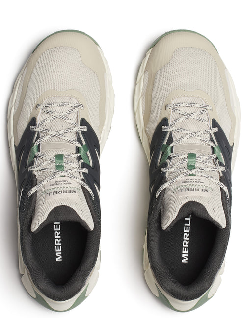 Top-down view of two off-white sneakers with black and green accents and white and gray laces; "MERRELL" printed on insole.