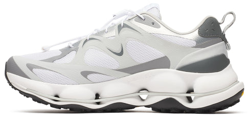 White athletic shoe with grey accents, featuring a uniquely designed sole with hollow spheres.