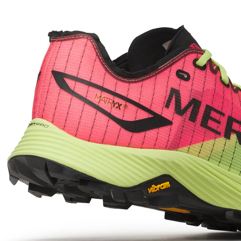Close up of a red and green running shoe with black accents. The shoe has the word "MER" written on the side and "MATRYX" written near the heel. The sole is yellow, and the tread is black.