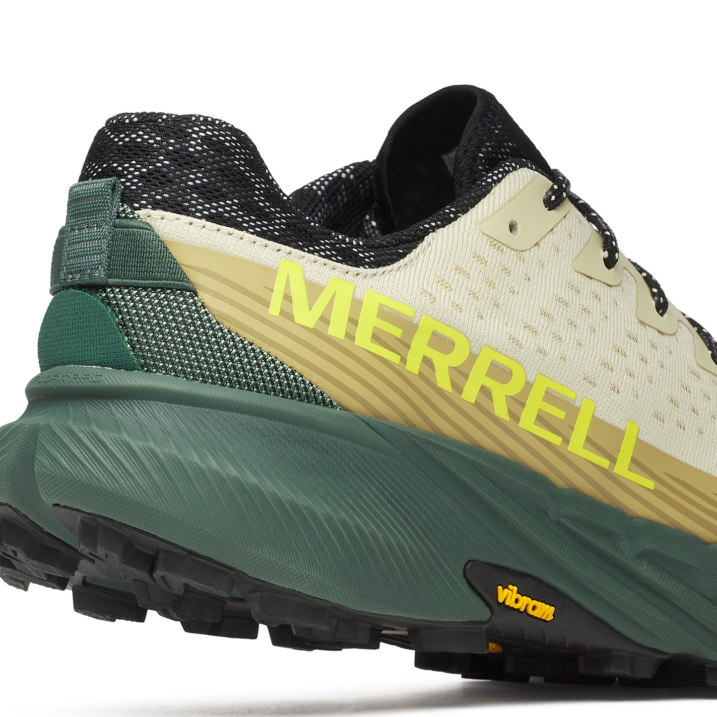 Close-up of a trail running shoe with a yellow logo 'MERRELL' on the side, green sole, and black laces.