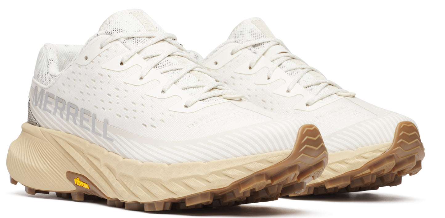 A pair of white running shoes with tan soles and the word MERRELL on the side.