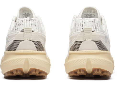 Back view of athletic shoes featuring a white and grey upper, cream midsole, and brown lugged outsole.