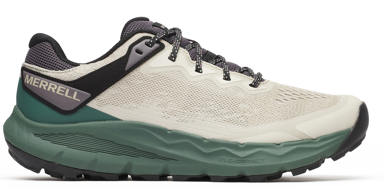 Side view of a shoe with a gray and black heel, a tan upper, and a green sole.