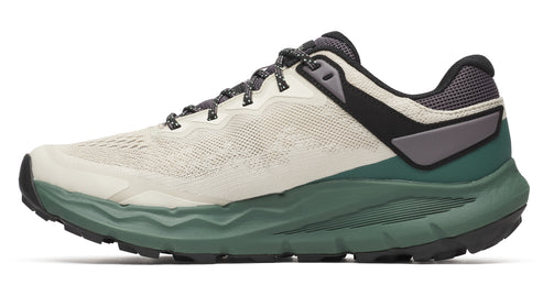Trail running shoe with a light tan upper, gray laces, black and gray heel, and green sole.