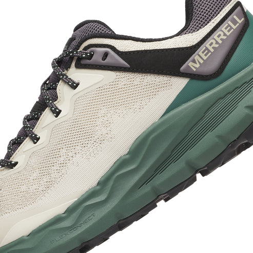 Closeup of a running shoe with a white mesh upper, a dark green midsole, and the word MERRELL in grey on the heel.