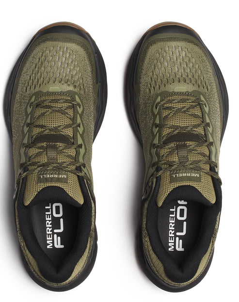 Overhead view of a pair of green sneakers with black soles.