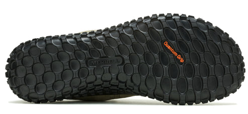 Close-up of a shoe sole displaying a pattern of textured black circles with 'Quantum Grip' printed in orange.