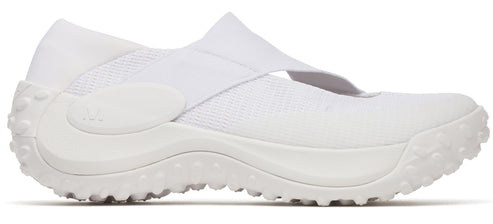 An all-white slip-on shoe with a thick, textured sole and an elastic strap across the instep.