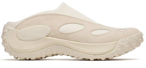 A neutral colored shoe with a chunky sole and oval cutouts on the side.