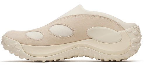 Beige slip-on shoe with circular details and chunky sole.