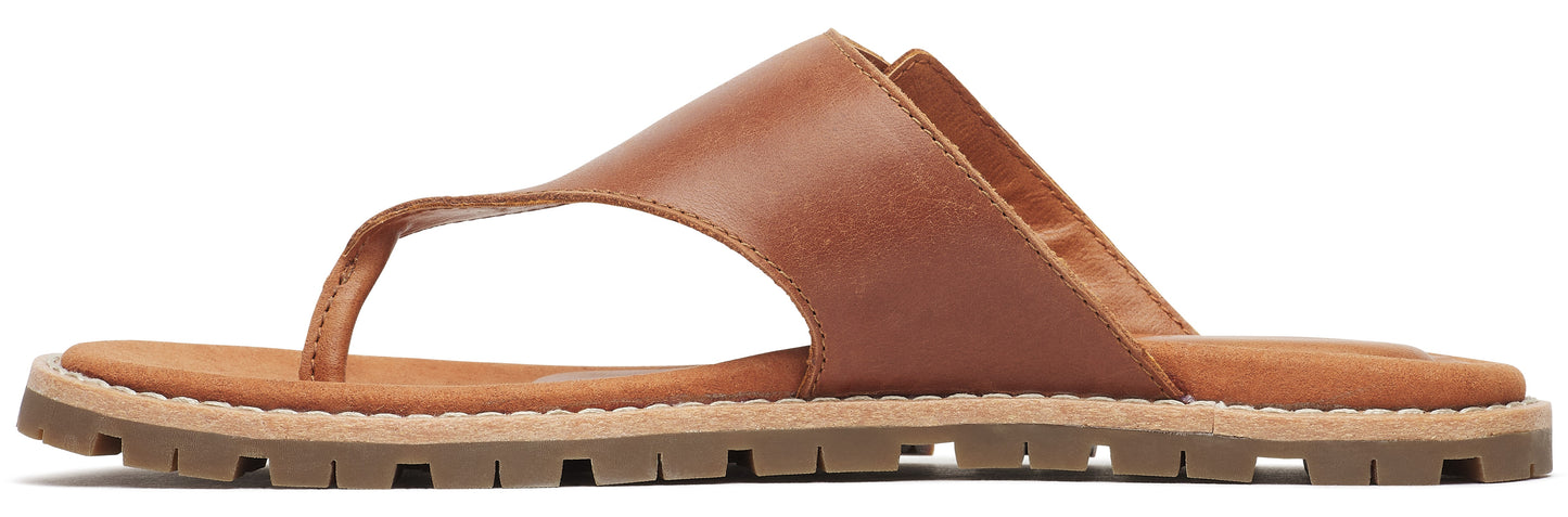 A tan leather thong sandal with a lug sole.