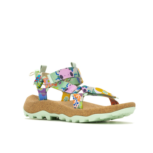 A side view of a sandal with light green soles and straps patterned with colorful floral and splotch designs.