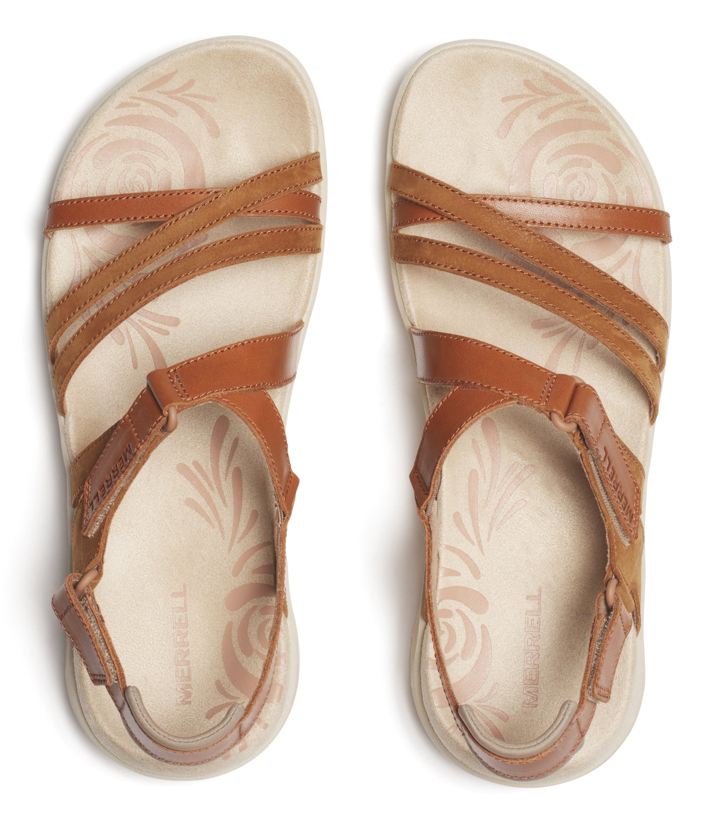 Overhead view of two tan leather sandals with thin straps crossing over the foot and adjustable heel straps on beige soles with subtle floral patterns.