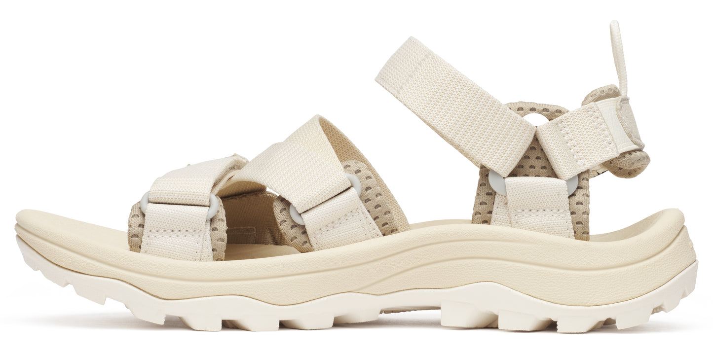 A beige sandal with thick straps and a chunky sole.