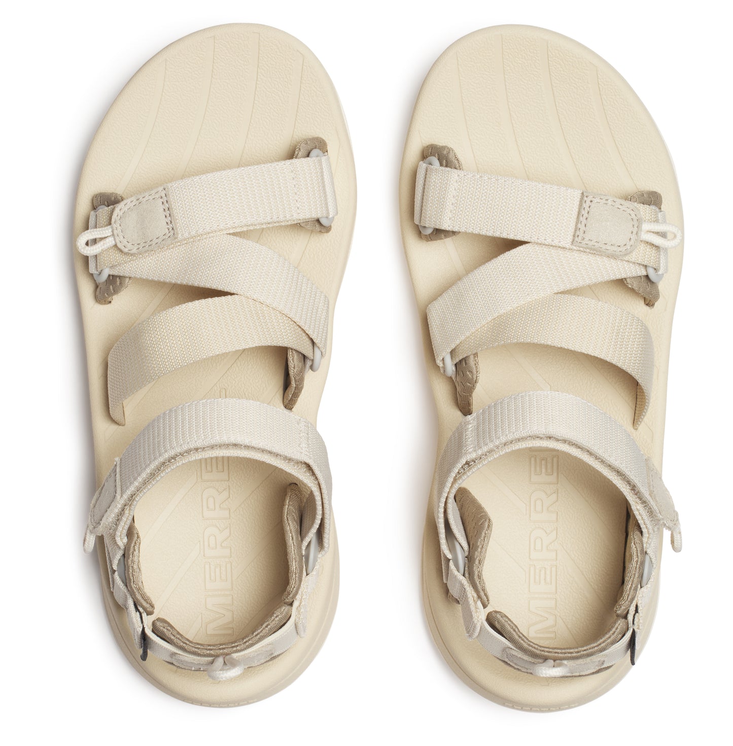 Overhead view of two cream-colored sandals with multiple adjustable straps.