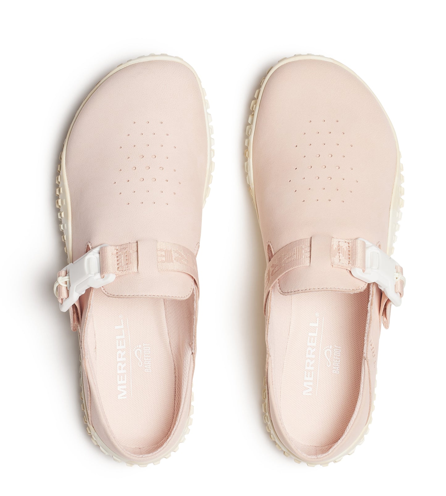 Pair of light pink clogs with a strap and buckle, featuring small perforations on top and the word "MERRELL" visible inside.