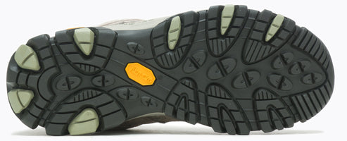 Sole of shoe with green and black textured pattern and yellow Vibram logo.