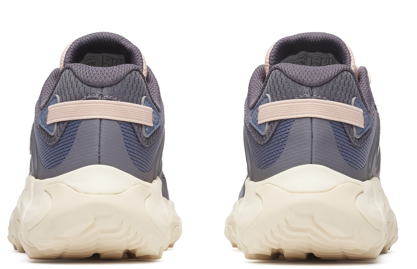 Two athletic shoes with gray mesh uppers, pink heel straps, and off-white textured soles, seen from the back.