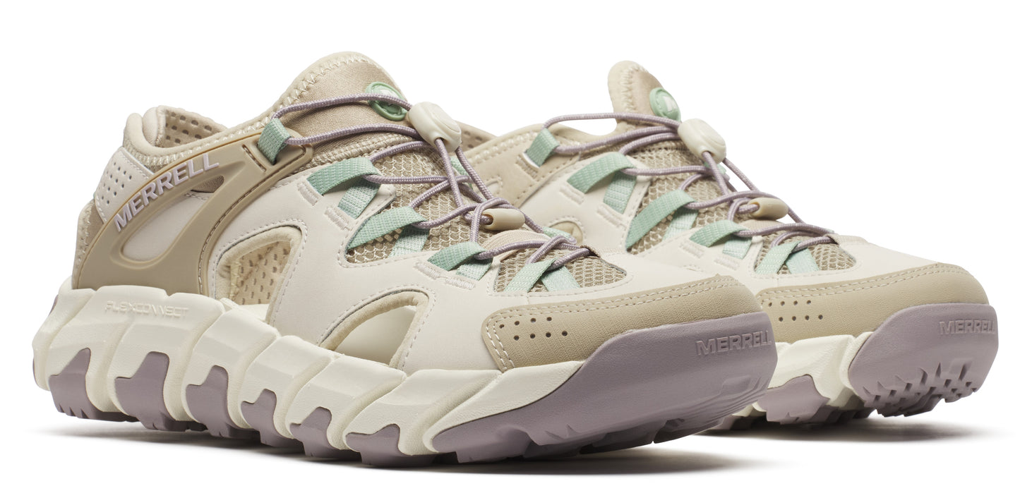 A pair of low-top, light-colored hiking shoes with thick soles and bungee-cord-style laces.