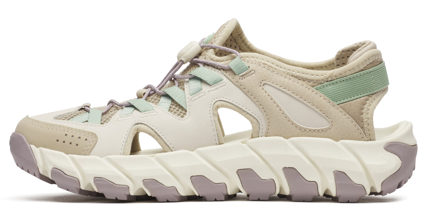 A sandal with a chunky, sculpted white and gray sole.