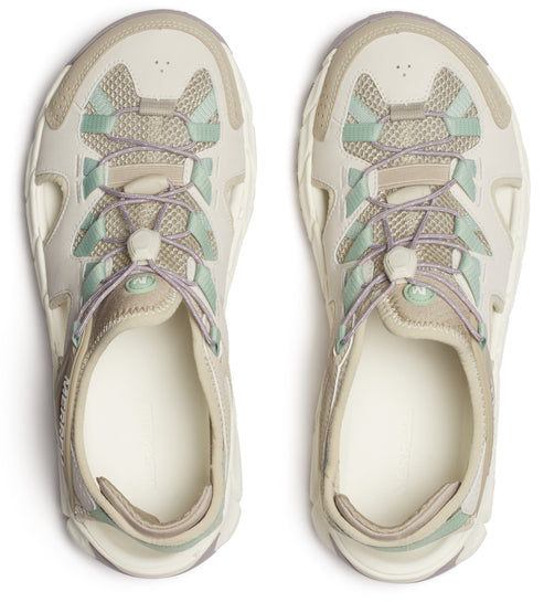 A pair of beige sandals with pale purple laces and mint green mesh.
