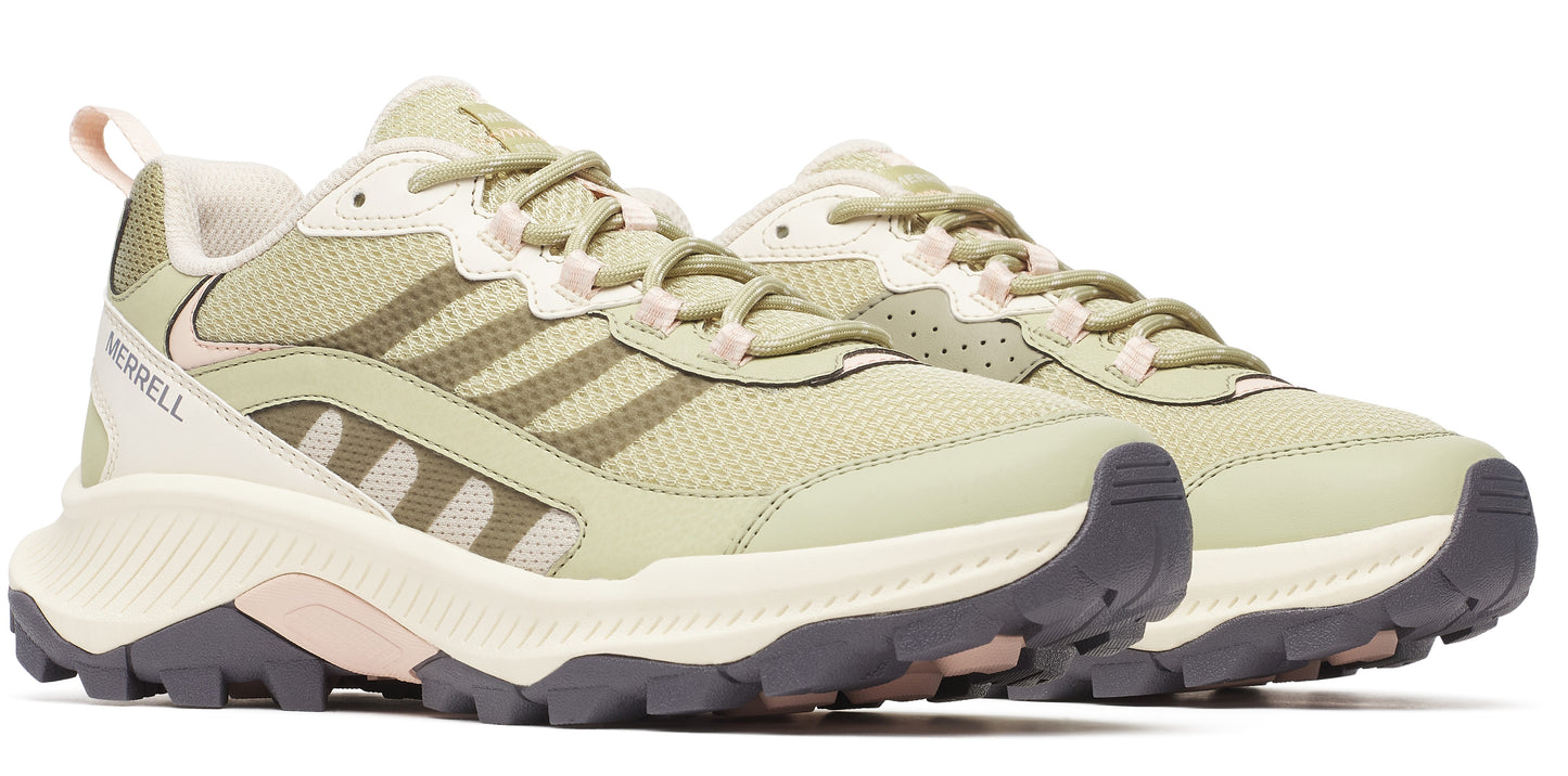 A pair of low-top trail running shoes with a green mesh upper, cream colored midsole, and dark grey outsole.