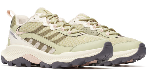 A pair of low-top trail running shoes with a green mesh upper, cream colored midsole, and dark grey outsole.