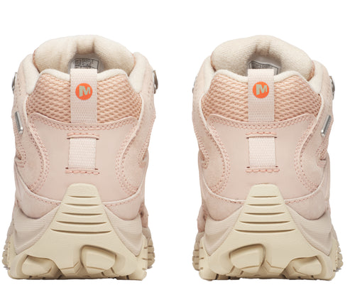 Back view of two light pink hiking boots with a light tan sole and an orange "M" logo on the back of the heel.