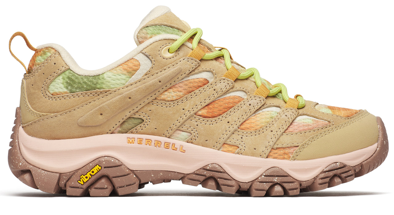 Low-rise tan hiking shoe with green and orange abstract designs, yellow laces, and tan speckled soles with a yellow vibram logo.