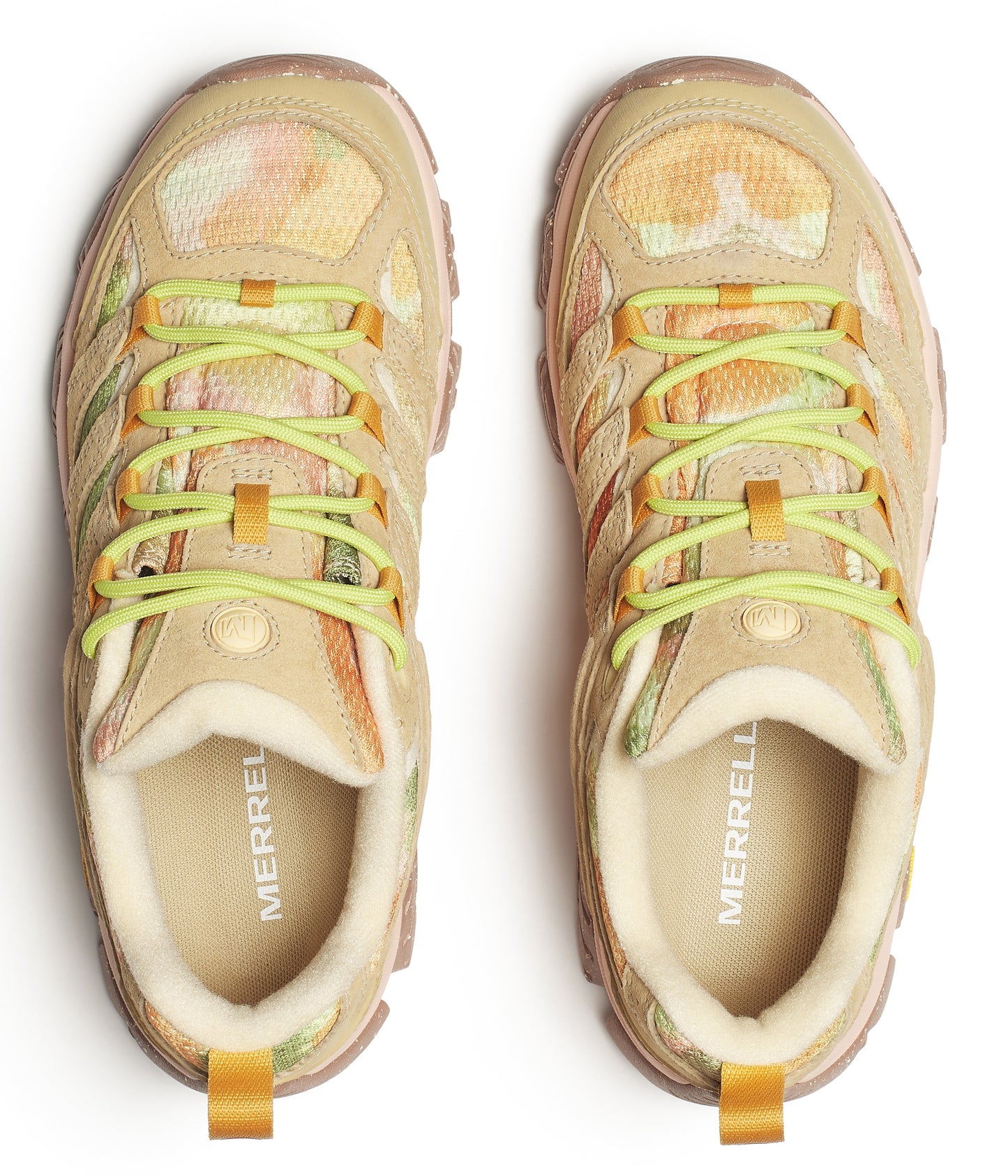 Top-down shot of two tan and orange trail running shoes with green laces; 'MERRELL' is printed on the insole.