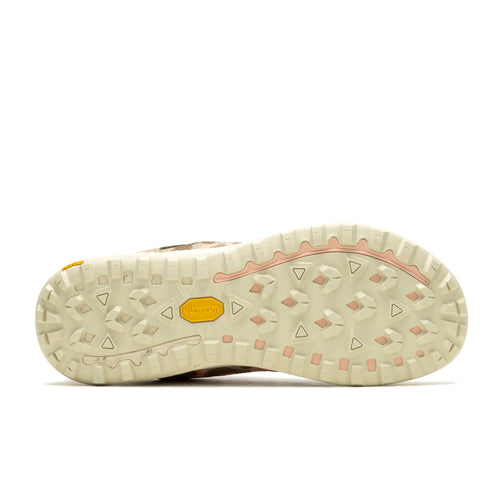 Beige shoe sole with diamond and triangle tread pattern, and a yellow Vibram logo.