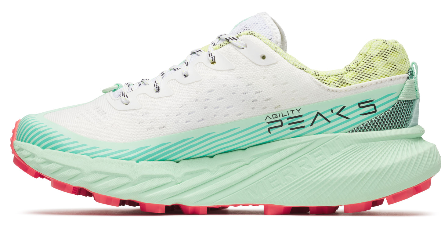 A white running shoe with green sole and pink accents.