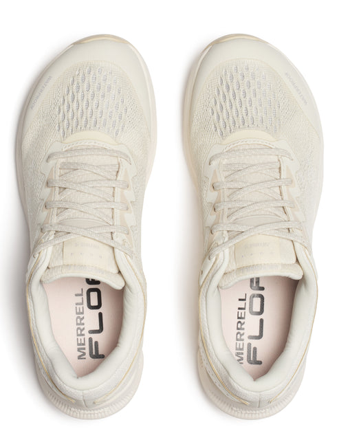 Overhead shot of two off-white sneakers with mesh uppers and visible "MERRELL FLOA" text on the inner sole.
