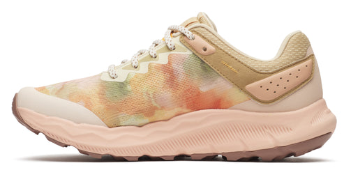 A side-view of a peach-colored shoe with a colorful textile and peach sole.