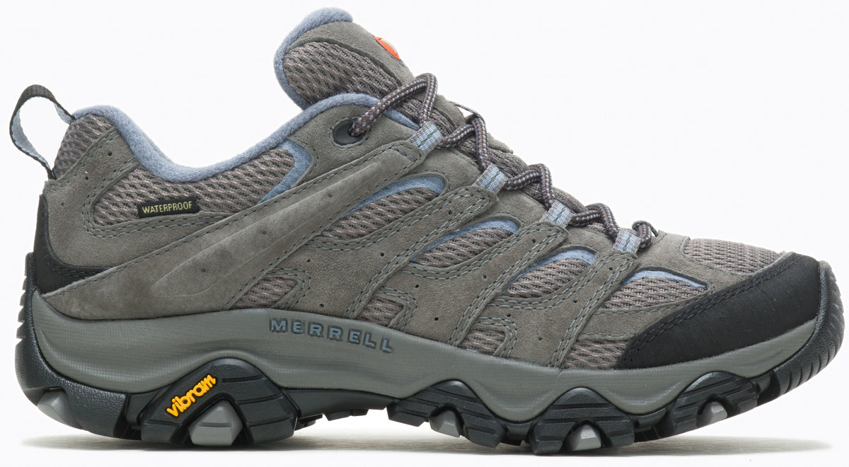 A gray waterproof hiking shoe with a breathable mesh and suede upper, a black protective toe cap, a padded collar, lace-up closure, and a rugged Vibram rubber outsole with multidirectional lugs.