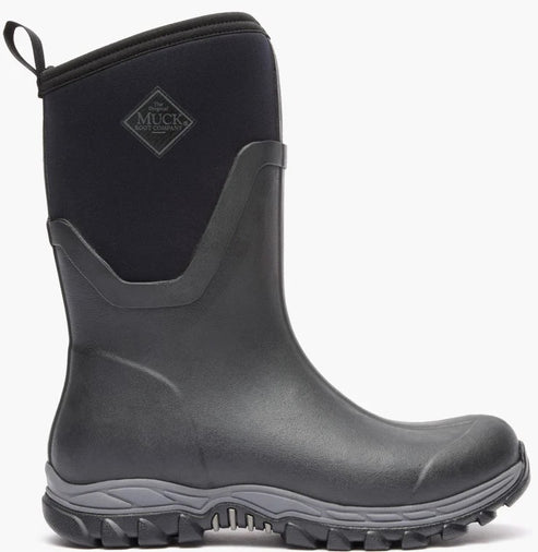 A black mid-calf rubber rain boot with a pull loop at the top, a gray patterned sole, and a visible MUCK BOOT COMPANY logo patch on the upper shaft.