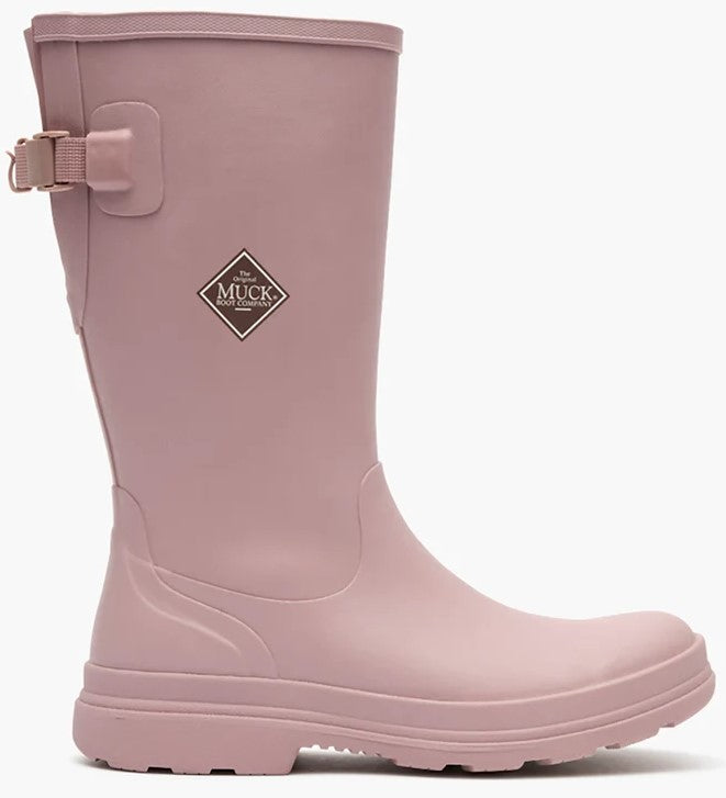 A light pink rubber boot featuring a side-buckle adjustment strap near the top and a diamond-shaped logo patch that reads 'The Original Muck Boot Company' on the upper calf area.