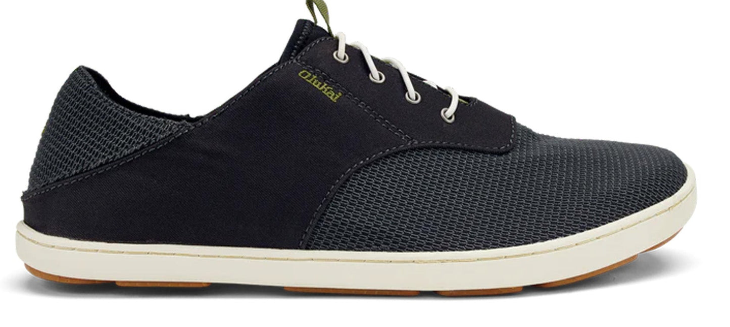 A black slip-on sneaker with white laces and a white sole.