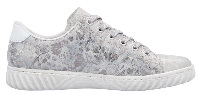 A sneaker with white floral-patterned fabric and a white sole.