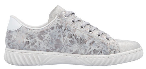 A sneaker with white floral-patterned fabric and a white sole.