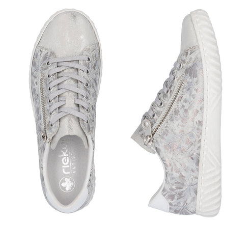 A pair of rieker lace-up sneakers with a side zipper and floral pattern in silver.